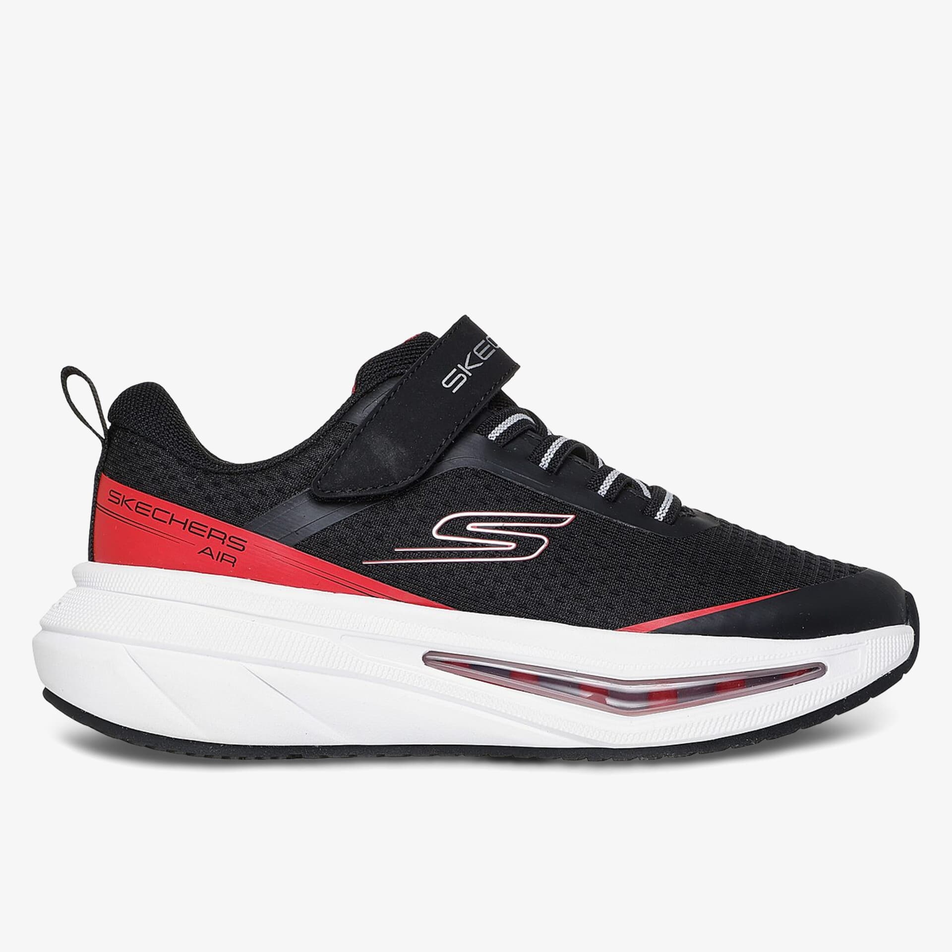 Schwarzer Sneaker mit roten Akzenten, Klettverschluss und weißer Sohle